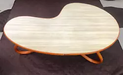 It has rattan curved legs and a light wood grain formica top. Only one original owner!