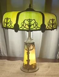 This antique table lamp is a stunning piece of art that will add a touch of elegance to any room. The lamp features...