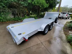 Open Feather Lite aluminum car trailer.  Includes factory front air dam, battery powered electric winch, mounted spare...