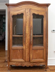 The doors are outfitted with a highly refined chicken wire reveal, door-length brass hinges, an original key with...