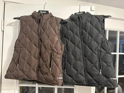 2 LADIES TOMMY HILFIGER PUFFER VESTS. SIZE LARGE. ONE BLACK COLOR, OTHER IS COCOA/CHOCOLATE COLOR. ONE INTERIOR CHEST...