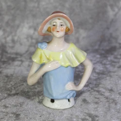 This is a lovely antique bisque half doll that is a lady holding her hat. The half doll is marked, 
