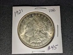 Nice coin below book. Exact coin listed. Any questions ask please no returns. 1921 Morgan silver dollar