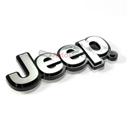 Injection molded emblem with a self-adhesive backing.