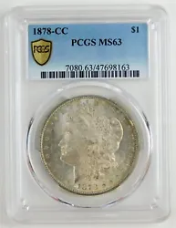 PCGS Mint State 63. Wilshire Coin. Light grayish and yellow orange toning on both sides. Struck at the Carson City...