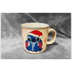 Cute, festive mug features Stitch dressed & ready for Christmas. Ceramic, w/thin blue highlight around rim, is...