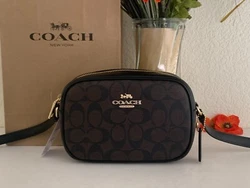 Style: C9926. Signature Canvas and leather. Zip closure, fabric lining. Inside multifunction pocket. Outside open...