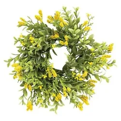 This is a new candle ring that has artificial green leaves and clusters of yellow berries.