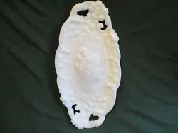 Lovely antique plate is a shiny translucent milk glass. A dark gray spot on back bleeds through slightly onto front...