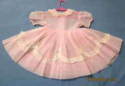 It has short sleeves, Peter Pan collar, sash ties in back. There are no stains, no holes, there is an open seam where...