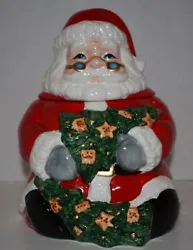 This festive cookie jar features Santa Claus with two decorated Christmas trees. This cookie jar should be hand washed...