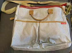 Skip Hop Stripped crossbody or shoulder Diaper Tote Bag.There are stains on the inside pockets and inside of tote bag....