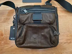 Very beautiful brown Tumi Barton Crossbody Leather bag, only used once or twice.  Absolutely no wear whatsoever and...
