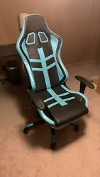 gaming chair. Recliner, adjustable arm rests, and leg rest with pillow included