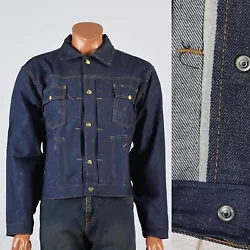 This is a jean jacket in dark denim. Logo snap buttons up the front, snap chest pockets, angled hip pockets, snap cuffs...