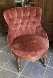 Victorian style Ladies crushed Red Velvet Mahogany Cherry Parlor Arm Chair with brass & wood rollers on the front legs....
