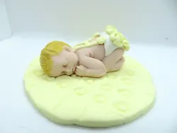 This baby is blonde and cute on her yellow blanket.