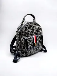Add some designer flair to your look with this Tommy Hilfiger Mini Backpack. Featuring a black faux leather exterior...