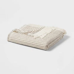 •Oversized woven throw blanket in ivory tone •Waffle-weave pattern •Fringed border •Midweight cotton-blend...