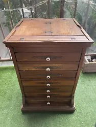 This antique spool cabinet is a beautiful and unique piece of furniture. The handmade design adds to its charm.