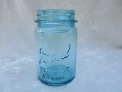 Dark aqua colored glass jar with 2 seams, one seam has roughness. tiny flea bite along inside top rim. In very good...
