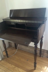 This antique desk is a beautiful addition to any room. Made of mahogany, this desk has a classic brown color that...