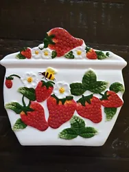 You are looking at a Ceramic trivet. It is white with beautiful colorful strawberries and strawberry flowers on a vine....