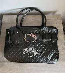 Black purse with Hello Kitty theme Full zip top closure 1 interior zip pocket. with kitty shape zipper pull Hello Kitty...