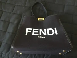 Pre-ownedFendi ROMA canvas, top handle, handbag navy blue. Handbag has red leather interior. Handbag is authentic to...