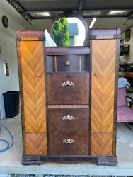 Features 3 dovetailed drawers flanked by side doors that reveal cedar closets with rods for hanging clothes. The center...