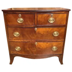 A beautiful diminutive English mahogany bow front chest with a subtle bow to the reeded edge rectangular top, and...