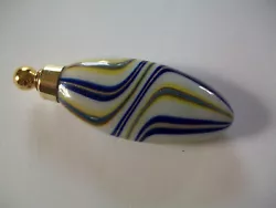 Gold glass dauber fits snugly. oval shape with swirls of navy, yellow & sparkly gold.