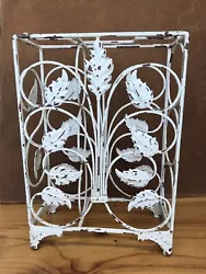 Mid Century Modern Metal Wine Rack. White with Floral Design. Holds 3 Bottles. It’s in good condition. It could be...