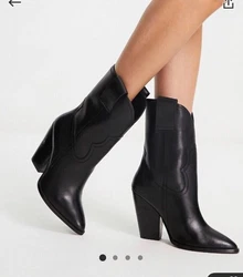 Black leather heeled cowboy boots in UK 5, US 7.5. The boots have a beautiful heel and are mid calf. Perfect for summer...