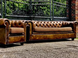 The couch and chair have a very nice look to the leather. The legs have been added to the couch and chair. They are...