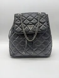 This bag featuresblack faux-leather. Guess logo plaque at front insilver. Silver-tone hardware. We commit to bringing...