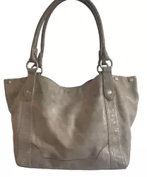 This is a very nice Frye leather tote. The striped fabric lining is in great condition. Genuine Frye soft gray leather....