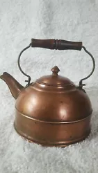 A beautiful kettle material copper, handle wood.