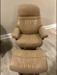 Extremely comfortable beige leather recliner with mahogany wood base. Good condition, slight wear on one armrest. Brand...