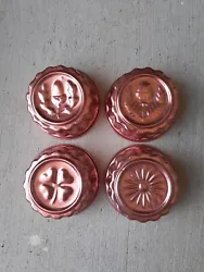 4 small round vintage molds. Not sure what the metal is. They are copper colored but not copper metal as far as I can...