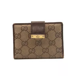 This is an authentic GUCCI Monogram Compact Wallet in Brown. This chic wallet is crafted of Gucci GG monogram canvas...