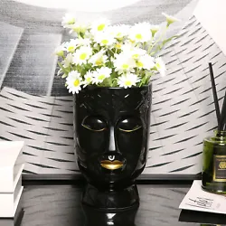 Modern black glazed ceramic planter and flower vase with sculpted face, painted gold lips and etched border rim Fill...