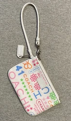 COACH Small White Wristlet with floral design, very good condition