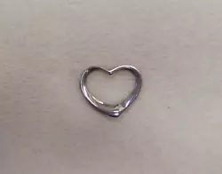 From Tiffany & Co. an open, floating heart charm, signed 
