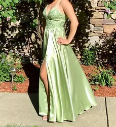 Prom dress FAVIANA light green, worn one time, looks brand new, gorgeous and has pockets! Has a tie back and has...
