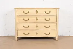 A gorgeous French Provincial Louis XV style dresser or chest of drawers. By Baker Furniture. Cream painted walnut, with...