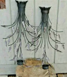 Artistic wall-hung candle holders of a bundled sticks and leaves design. Displays nicely above furniture such as beds...
