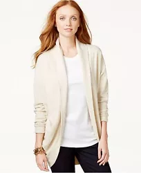 No collar. Pull-on styling; open front. Long sleeves. Allover solid coloring. Loose fit. Straight hem. Hits below hip....