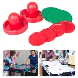 Set of two air hockey pushers and four air hockey pucks. Pushers have green felt on bottom. .