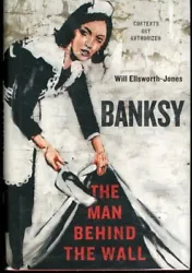 Banksy: The Man Behind the Wall. First Edition. A Near Fine, red binding with black lettering on spine, binding firm,...